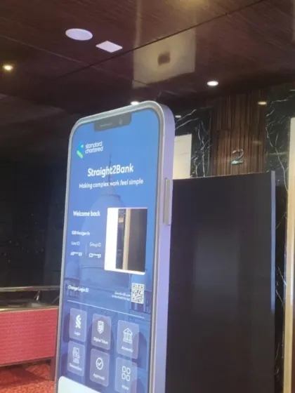 A wider shot of the custom Selfie Booth we created for Standard Chartered. The life-sized phone frame served as a perfect photo op, seamlessly integrating the brand's digital product into a physical event experience.