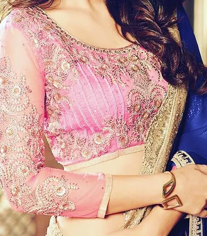 A full-sleeve blouse with heavy embroidery is a classic choice for silk sarees. I ensure the sleeve fit is perfect and the embroidery is seamless.