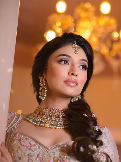 A classic portrait against a warm, glowing background, highlighting the soft contour and the shimmer on the eyes.
