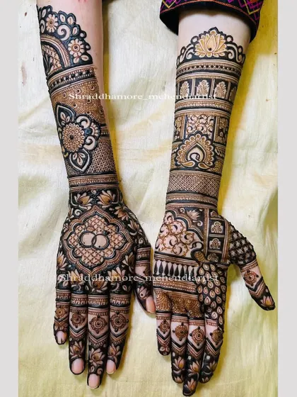 This engagement mehendi features a beautiful symmetry, with intricate patterns extending up the arms. I incorporated the classic symbol of intertwined rings on the palm, surrounded by detailed floral and geometric work.