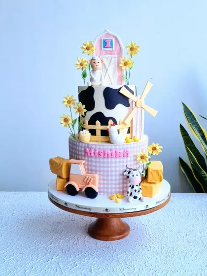 A full view of the three-tiered farm cake, showing all the adorable details.