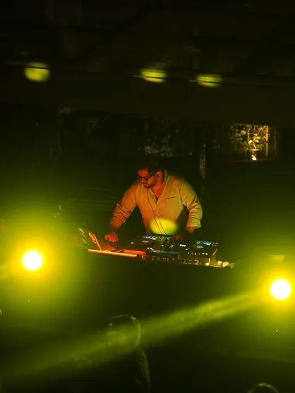 Another angle from the same gig, with yellow lights creating a warm glow.
