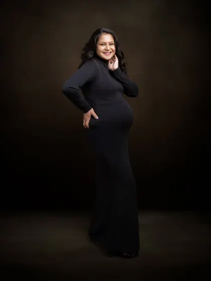 There's a quiet strength in simplicity. This portrait says it all, with no props or distractions, just confidence, elegance, and the joy of motherhood in a classic black dress.