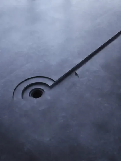Even functional details are inspired by nature. This custom drain cover, with its clean, geometric lines carved into the stone, mimics the patterns of water flowing, showing our attention to detail at every scale.