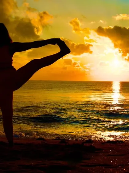Finding my balance with the rising sun. This is Utthita Hasta Padangusthasana, a standing balance pose that challenges focus and strengthens the legs, captured during a peaceful morning by the sea.