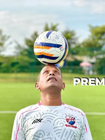 A creative shot of Coach Prem, balancing a ball on his head.