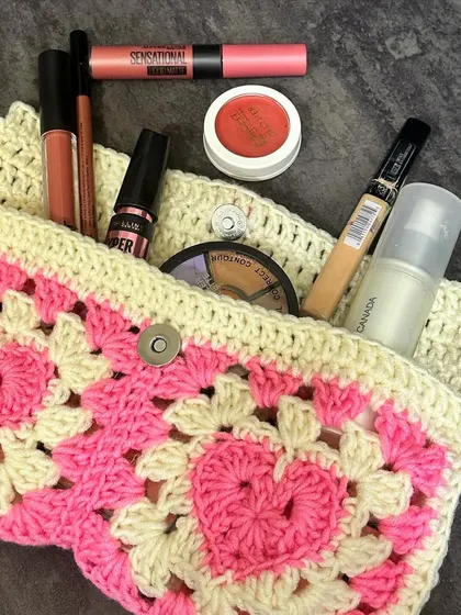 Here’s the heart granny square pouch filled with makeup to give you an idea of its size. It’s a stylish way to keep your bag organized.