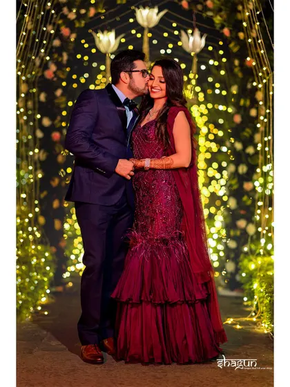 A sweet kiss on the cheek under a tunnel of fairy lights. This is the kind of romantic shot that makes hearts melt.