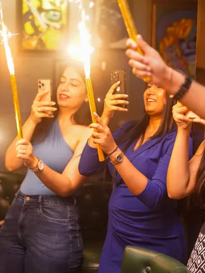 Guests capturing the sparkler moment on their phones.