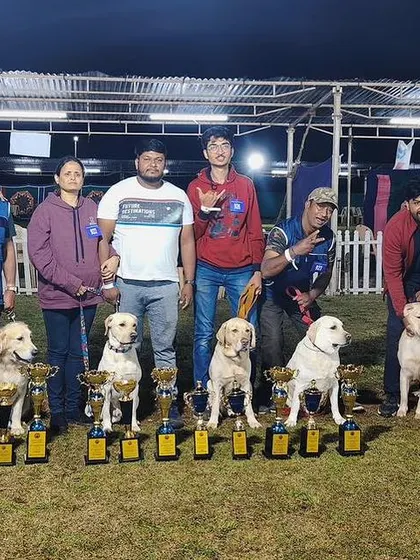 The K9 Gurukul team posing with our champion dogs and their many trophies.