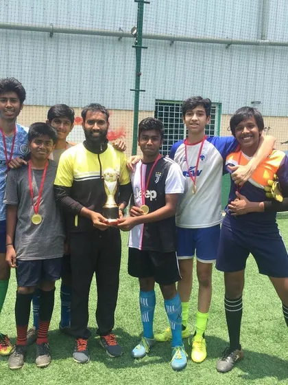 Our U-16 football champions with their coaches, holding the Stallion Football Cup trophy. We are proud to guide these talented young athletes.