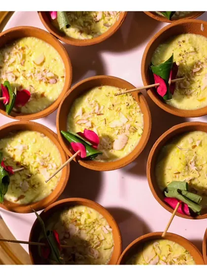 An overhead shot of our Paan Rabri served in traditional clay kulhads, garnished with nuts and edible silver leaf for a rustic yet refined dessert.