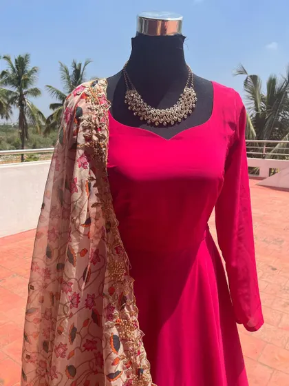 A simple and elegant pink Anarkali with a floral embroidered dupatta.