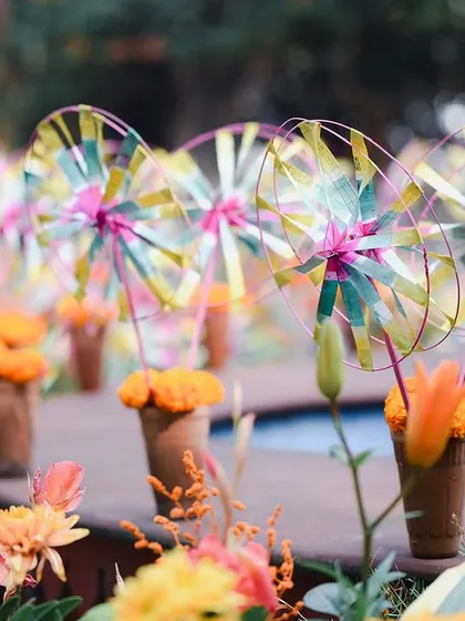 A detail from a garden Mehendi, where colorful pinwheels were placed in terracotta cones. This playful element added a touch of handmade charm and whimsy to the vibrant, sun-kissed setting.