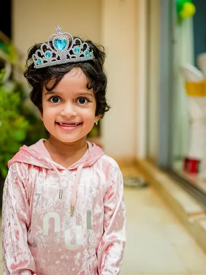 A sweet portrait of the birthday girl, looking like a little princess in her tiara and smiling for the camera.