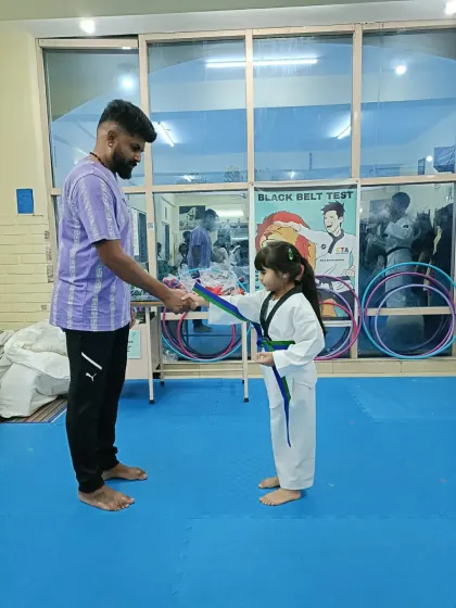 Tying a new belt for a young girl.