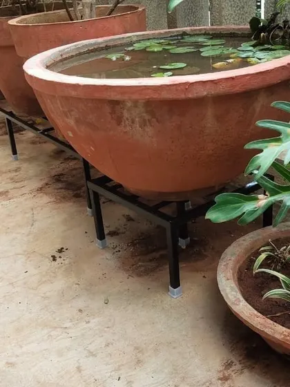 This close-up shows how our stand provides sturdy support for a very large and heavy terracotta water feature, making it a safe and beautiful centerpiece for this balcony garden.