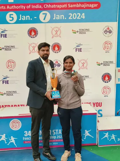 I am presenting the trophy and medal to Harshada Wadte for her bronze medal win at the 34th Senior State Fencing Championship. We support fencers through every stage of their career, including the senior level.