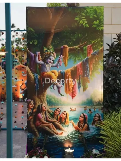 A large, beautifully printed backdrop depicting a classic Krishna leela scene, used as part of the outdoor decor for a Vrindavan-themed event.