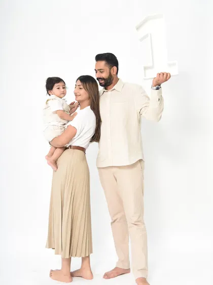 A proud family celebrating a major milestone. Including family in first birthday shoots makes the memories even more special.