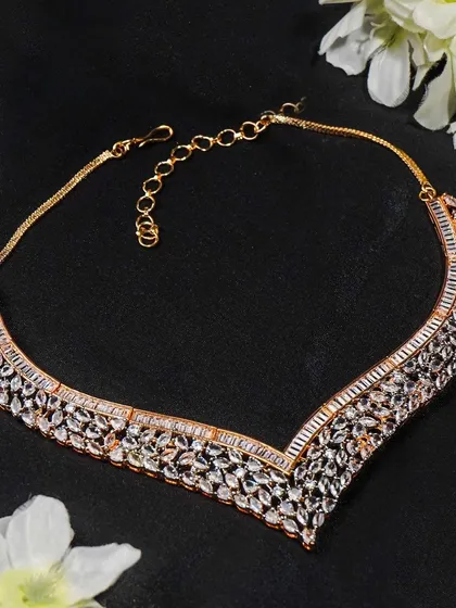 This shot of a rose gold necklace is styled with soft white flowers to create a romantic and elegant mood. It's perfect for wedding or occasion-wear collections.