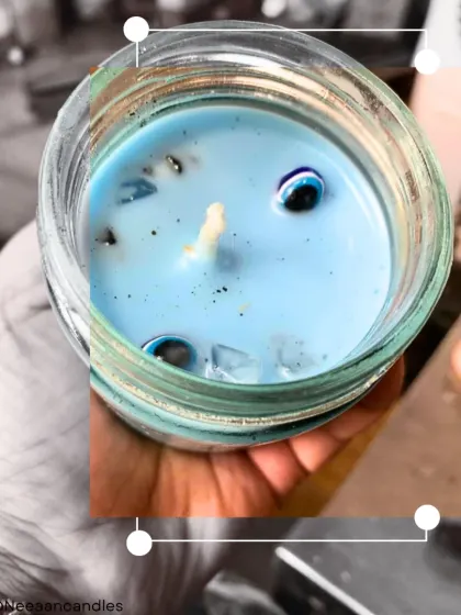 This is my Evil Eye protection candle, hand-poured in a glass jar. I've infused it with protective crystals and evil eye beads to keep your space energetically clean and safe.