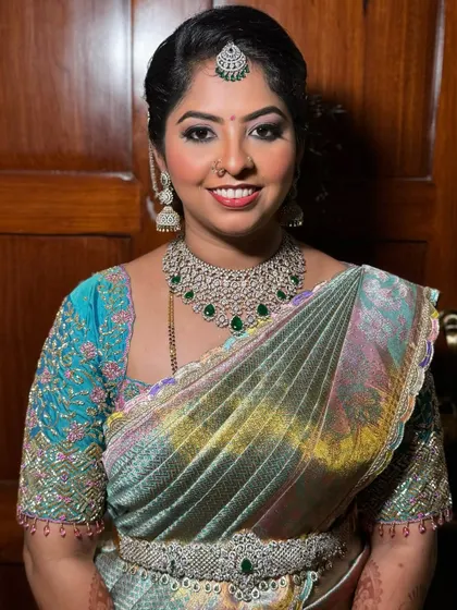 Ashritha's reception makeup. We went for a glamorous look with defined eyes, emerald green accents to match her jewellery, and a glossy nude lip.