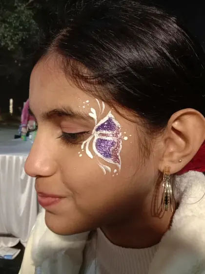 A purple glitter butterfly with elegant white swirls. This is a classic design that always looks magical, especially at night.