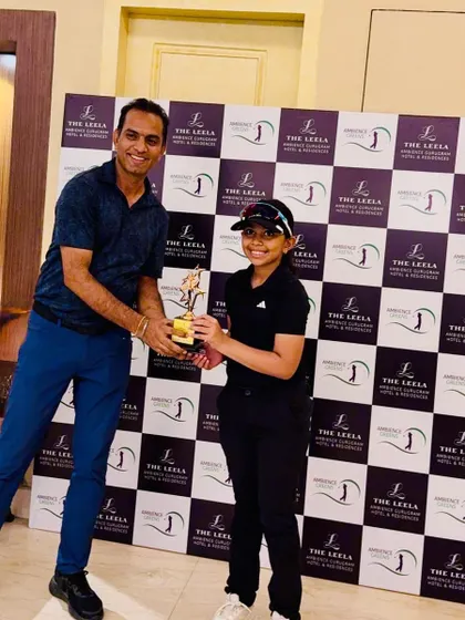 Aahana Shrivastava receives her 1st place trophy at The Leela Golf Greens Junior Golf Cup.