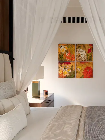 Another beautiful detail of the master bed, where the soft, layered bedding and sheer curtains create a haven of comfort.