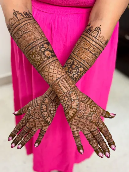 A crossed-arm pose, perfect for showing off the full extent of your bridal mehendi.