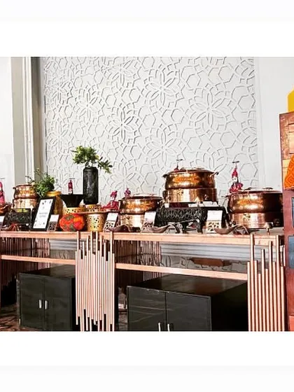 Another view of our buffet setup, this time with rustic wooden elements and Rajasthani puppets, adding a touch of folk art and color to the decor.
