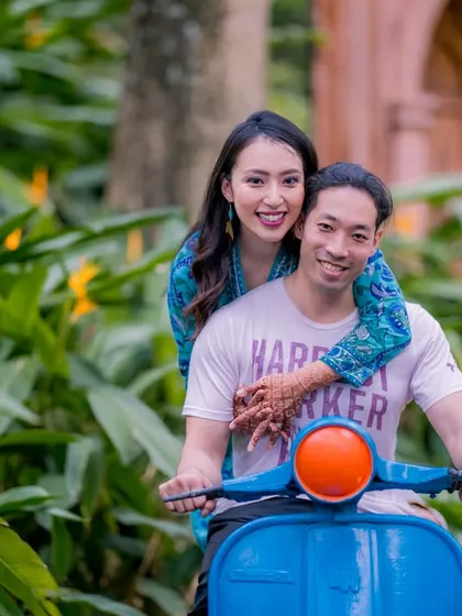 A happy, relaxed moment on a scooter. This shot captures the fun and adventurous spirit of the couple, surrounded by lush greenery.