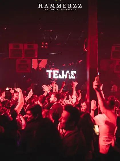 The crowd with their hands up at Hammerzz, with my name lit up on screens across the club.