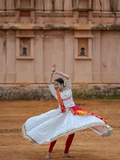A solo shot capturing the joy of a Kathak spin. The 'chakkar' is one of the most exciting elements of Kathak, requiring balance, speed, and grace.