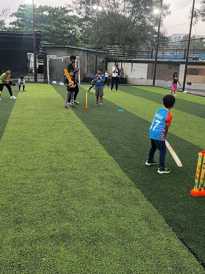 Kids enjoying a game of cricket on the turf. We organize the teams and rules to keep the game moving and fun for all skill levels.
