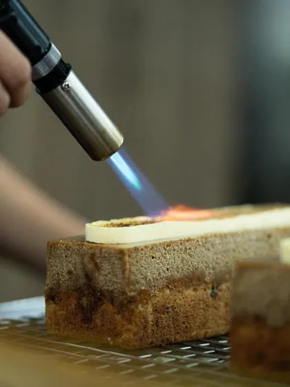 Using a blowtorch to caramelize the top of a dessert. This technique adds a beautiful color and a delicious toasted flavor.