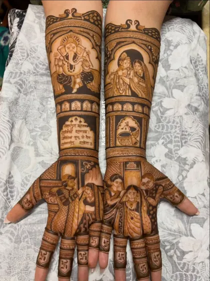 A divine and intricate bridal mehandi. This design features large portraits of Lord Ganesha and Radha-Krishna, along with detailed scenes of wedding rituals on the palms.