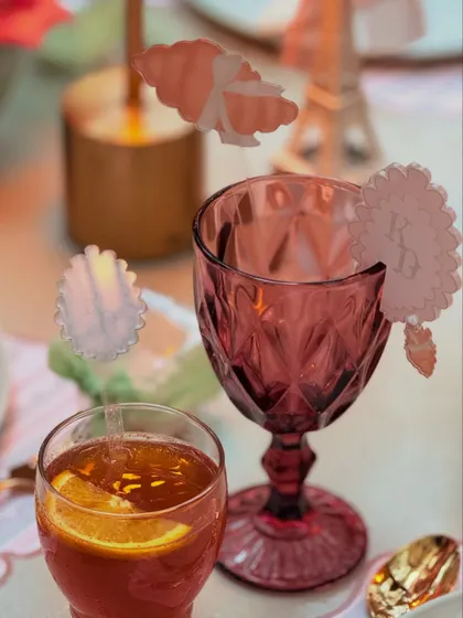 Custom acrylic drink stirrers and monogrammed glass tags add a layer of personalized elegance to the beverage service at the Parisian baby shower.