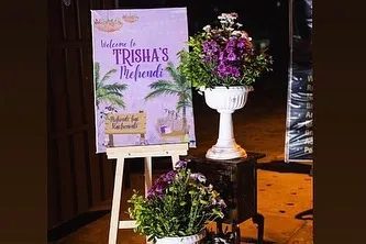 An identical image of the custom welcome sign for the Mehendi function, showing how I use floral arrangements to enhance even the smallest decor elements.