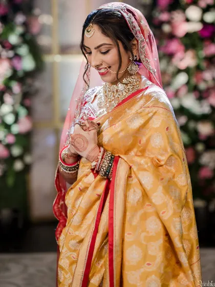 This bride chose a beautiful yellow saree for one of her ceremonies. The makeup is soft and glowing, with a touch of red on the lips to tie in with the border of her saree.
