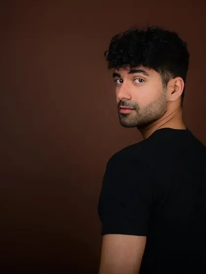 A classic actor's headshot with a look over the shoulder. This intense and direct gaze is exactly what casting directors look for, showing a range of emotion with just a glance.