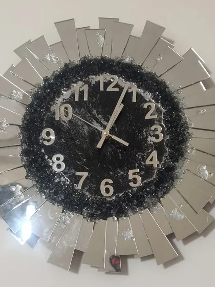 I love how this sunburst wall clock turned out! It's a real statement piece, made with a mix of sparkling crushed glass and mirrored accents to catch the light beautifully. We can customize the colors to match your living room decor.