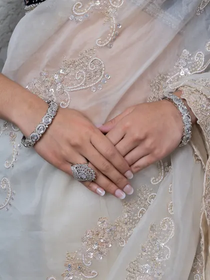 A detailed shot of the diamond-look bangles and ring. These pieces add a touch of luxury and elegance to any outfit.