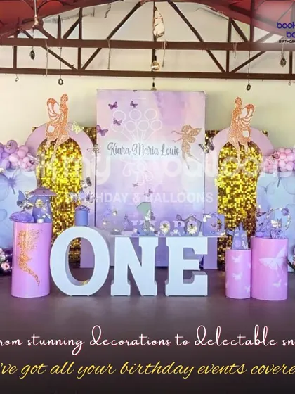 For this first birthday, I created an elegant fairy theme with purple and gold decor, sparkling sequin backdrops, and large "ONE" letters for a magical photo opportunity.