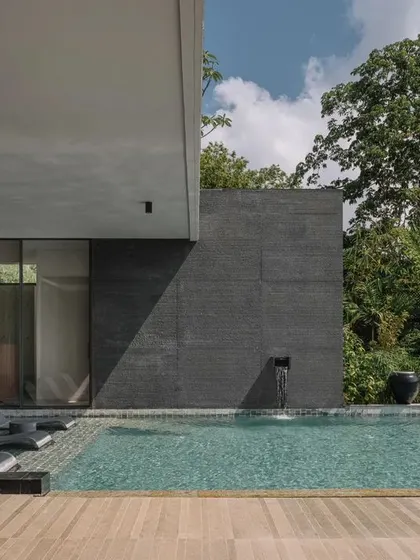 The pool area at GAIA, showcasing the minimalist architecture and its relationship with the dense, tropical foliage. The design is all about creating a private, serene outdoor sanctuary.
