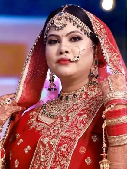 A classic Indian bride in a traditional red lehenga. I aimed for a timeless and graceful look, with perfectly defined features and makeup that complements her beautiful jewelry and outfit for her main wedding day.