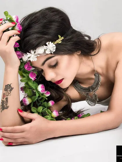 A close-up from the 'GAIA' series. This intimate shot focuses on the model's serene, closed-eye expression and the floral details, enhancing the theme of a goddess at peace with nature.