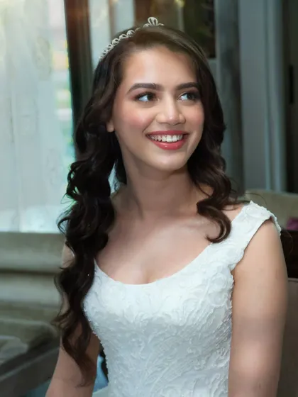 That smile says it all. Crystal's joy is infectious, and her natural glam makeup with a rosy lip and soft curls perfectly captures her bright personality.