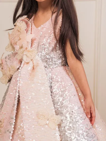 A close up of the handcrafted floral appliqué and sequin work on our pink and silver gown.